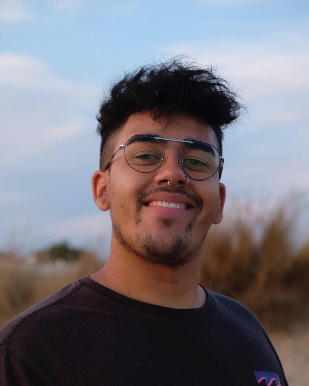 Portrait of Andrés Rey, Webflow and AI frontend developer, smiling outdoors
